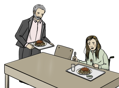 Eine Frau im Rollstuhl sitzt vor einem Teller mit Essen. Ein Mann setzt sich, ebenfalls mit Essen, zu ihr.